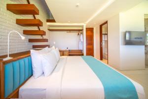 a bedroom with a large bed in a room at IZE Canggu by LifestyleRetreats in Canggu