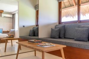 a living room with a couch and a coffee table at IZE Canggu by LifestyleRetreats in Canggu
