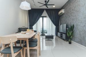 a dining room and living room with a table and chairs at Tranquil Sea View Danga Bay 3BR 6pax by Our Stay in Johor Bahru