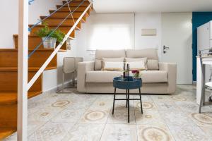a living room with a couch and a table at Casa El Palo in Málaga