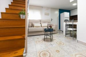 a living room with a couch and a table at Casa El Palo in Málaga
