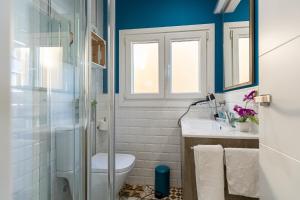 a bathroom with a toilet and a glass shower at Casa El Palo in Málaga +23 photos