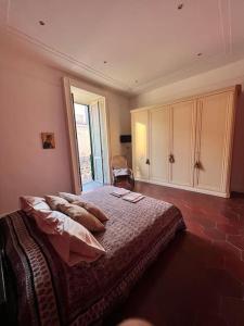 a bedroom with a bed and a large window at "Le Muse" a Ercolano in Ercolano