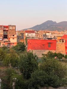 a city with a red building on a hill at "Le Muse" a Ercolano in Ercolano
