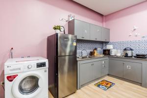 a kitchen with a refrigerator and a washing machine at The blue mountain pool villa cha-am in Ban Hup Kaphong