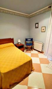 a bedroom with a yellow bed and a chair in it at Apartamento en Torreblanca Ref 061 in Torreblanca