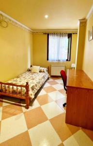a bedroom with a bed and a checkerboard floor at Apartamento en Torreblanca Ref 061 in Torreblanca