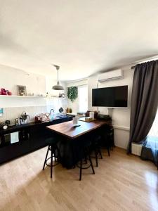 a kitchen with a desk and a table in a room at Apartment PM in Zagreb