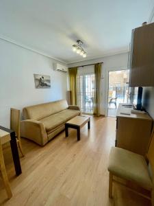 a living room with a couch and a table at Apartment Costa Azahar II Ref 012 in El Borseral