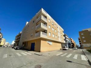 a tall apartment building on a city street at Apartment Grao de Moncofar Ref 041 in Moncófar