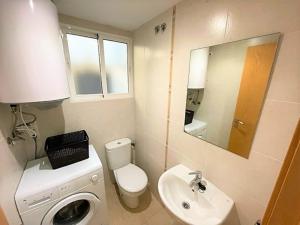 a small bathroom with a toilet and a sink at Apartment Grao de Moncofar Ref 041 in Moncófar +14 photos