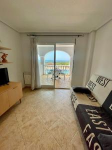 a living room with a couch and a view of the ocean at Apartamento Vacacional Vela Blanca Moncofa Ref 055 in Peniscola