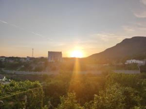 a view of the sun setting over a city at Apartments Pravica in Trebinje