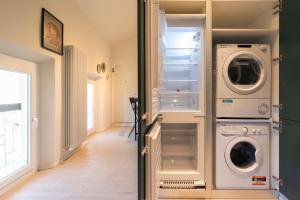 a laundry room with a washer and dryer at Reggio Center Lovely Rooms in Reggio Emilia