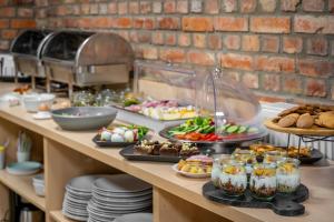 un buffet con muchos tipos diferentes de comida en una mesa en Aparthotel Platinum, en Szczecin