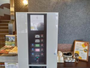 a refrigerator with a cell phone inside of it at Kitami Towa Hotel in Kitami