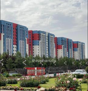 eine Gruppe großer Gebäude in einer Stadt in der Unterkunft Br group in Schymkent