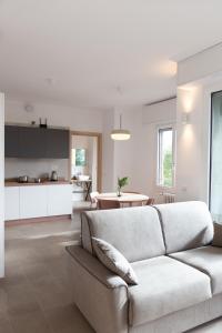 a living room with a couch and a kitchen at New Exclusive Melegnano Apartments- Near train station in Melegnano