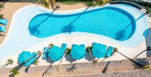 an overhead view of a swimming pool with blue chairs at IZE Canggu by LifestyleRetreats in Canggu