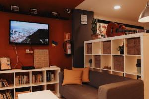 a living room with a couch and a flat screen tv at Onefam Ramblas in Barcelona