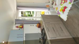 a kitchen with white cabinets and a glass wall at Happy Camp mobile homes in Camping La Vecchia Torre in Gallipoli
