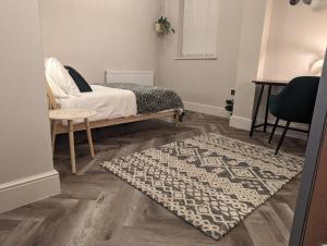 a bedroom with a bed and a rug at Wellington Circus in Nottingham