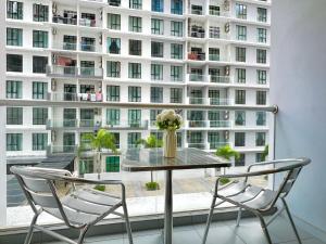 a table and chairs in front of a large building at The Platino By Antlerzone in Johor Bahru