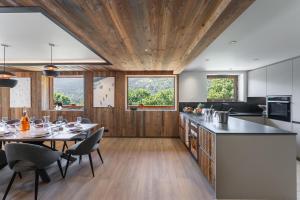 a kitchen with a table and chairs and a dining room at Chalet Carriaz Meribel Village 14pers à 5min à pieds des pistes et commerces in Les Allues