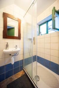 a bathroom with a glass shower and a sink at Sklípek Na Císařské in Moravany