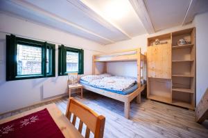a bedroom with a bunk bed and a table at Sklípek Na Císařské in Moravany