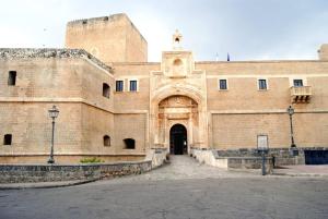 a large brick building with a large doorway at Over The Top - Lu Sule in Copertino