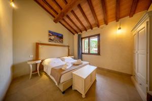 a bedroom with a bed and a table and a window at Resort Capalbio in Capalbio +97 photos