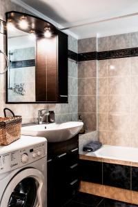 a bathroom with a washing machine and a sink at Va Yia/ Spacious guest house in Nafplio