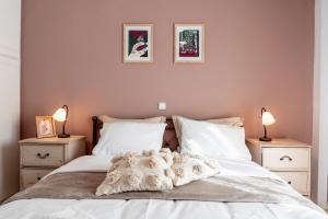 a bedroom with a white bed with two night stands at Va Yia/ Spacious guest house in Nafplio
