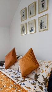 een bed met kussens en foto's aan de muur bij Private Double Bedroom in front of the Galway Port - Guest House in Galway