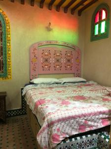 A bed or beds in a room at Riad Razoli Sidi Fateh