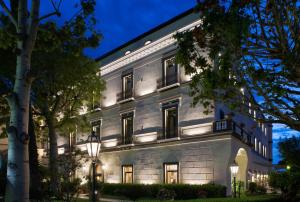 an exterior view of a building at night at Grand Hotel Cocumella in Sant'Agnello