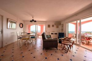 een woonkamer met een bank en een tafel en stoelen bij Esprit du Sud Mascolo in Roquebrune-sur-Argens