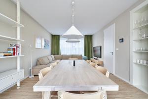 a living room with a table and a couch at Tatra Green in Veľká Lomnica