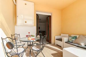 a living room with a table and chairs and a couch at Casa Mabel Terrace - Lecce Selection in Lecce
