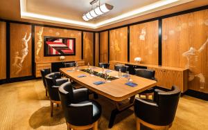 a conference room with a large wooden table and chairs at Dinamo Hotel Baku in Baku +37 photos