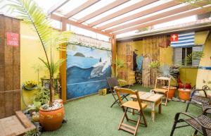 a room with plants and a table and chairs at Ubatuba Wild Hostel in Ubatuba