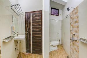 a bathroom with a shower and a toilet and a sink at FabHotel SR in Varanasi