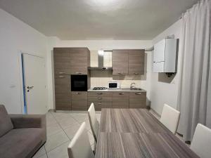 a kitchen and dining room with a table and chairs at SOTTOMARINA Beach Apartment in Sottomarina
