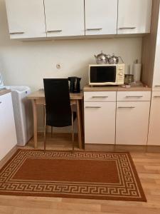 a kitchen with a table and a microwave at Luxury apartment with nice interior look for Guest in Krefeld