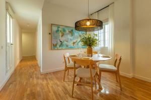 a dining room with a table and chairs at Triana Deluxe by Valcambre in Seville