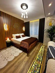a bedroom with a bed and a chandelier at İstanbul Houses Sabiha Gökçen Airport Hotel in Istanbul
