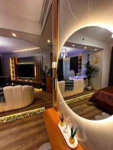 a living room with a large mirror in a room at İstanbul Houses Sabiha Gökçen Airport Hotel in Istanbul
