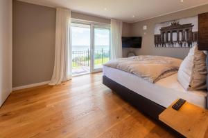 a bedroom with a bed and a large window at Villa "Haus am Meer" in Dahme