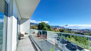 a balcony with a view of a city at 24, The Townhouse by LovelyStay in Funchal